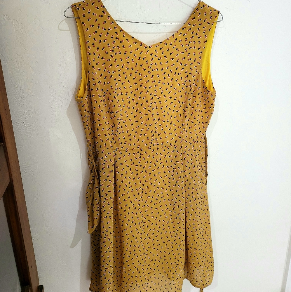 Yellow dress with black and red hearts.